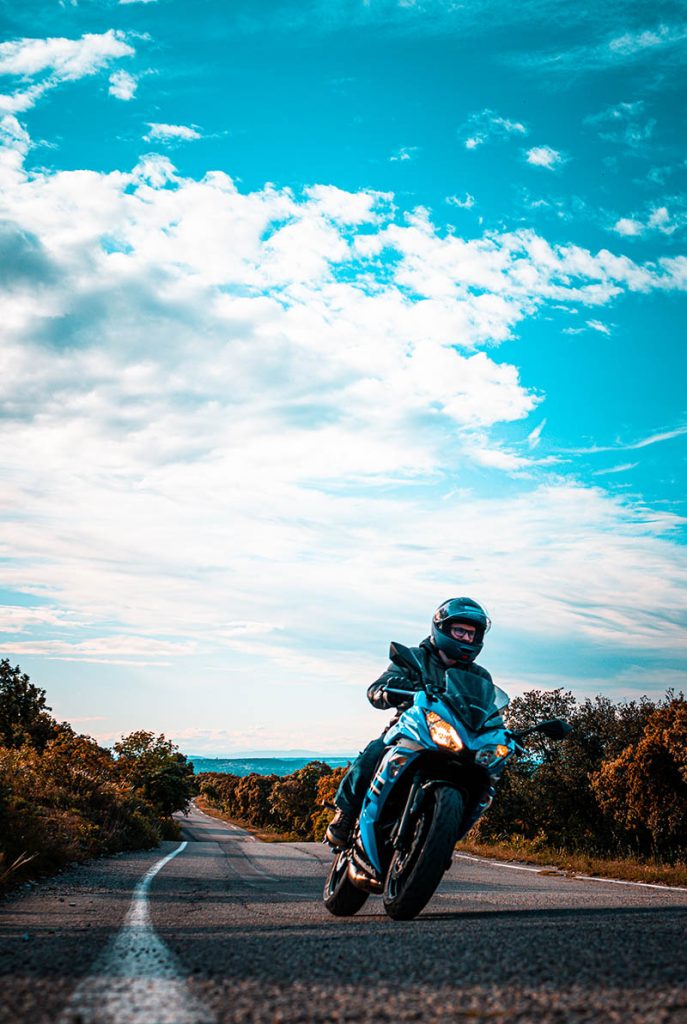 Motard sur une route côtière