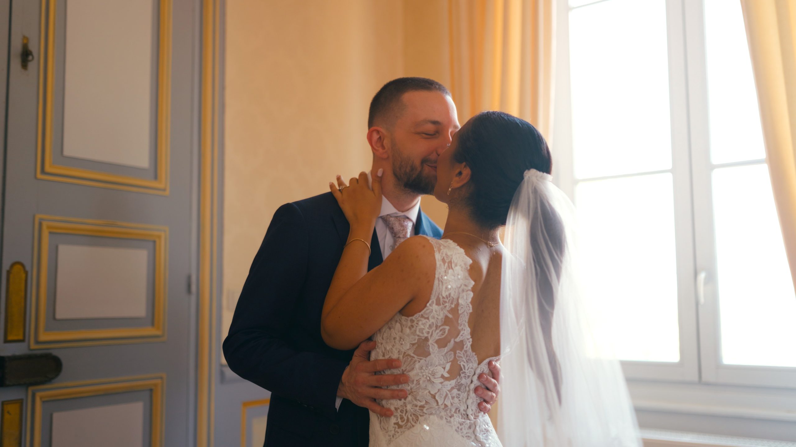 Dorian kissing Angélique in a bright drawing room of the château, just before the ceremony