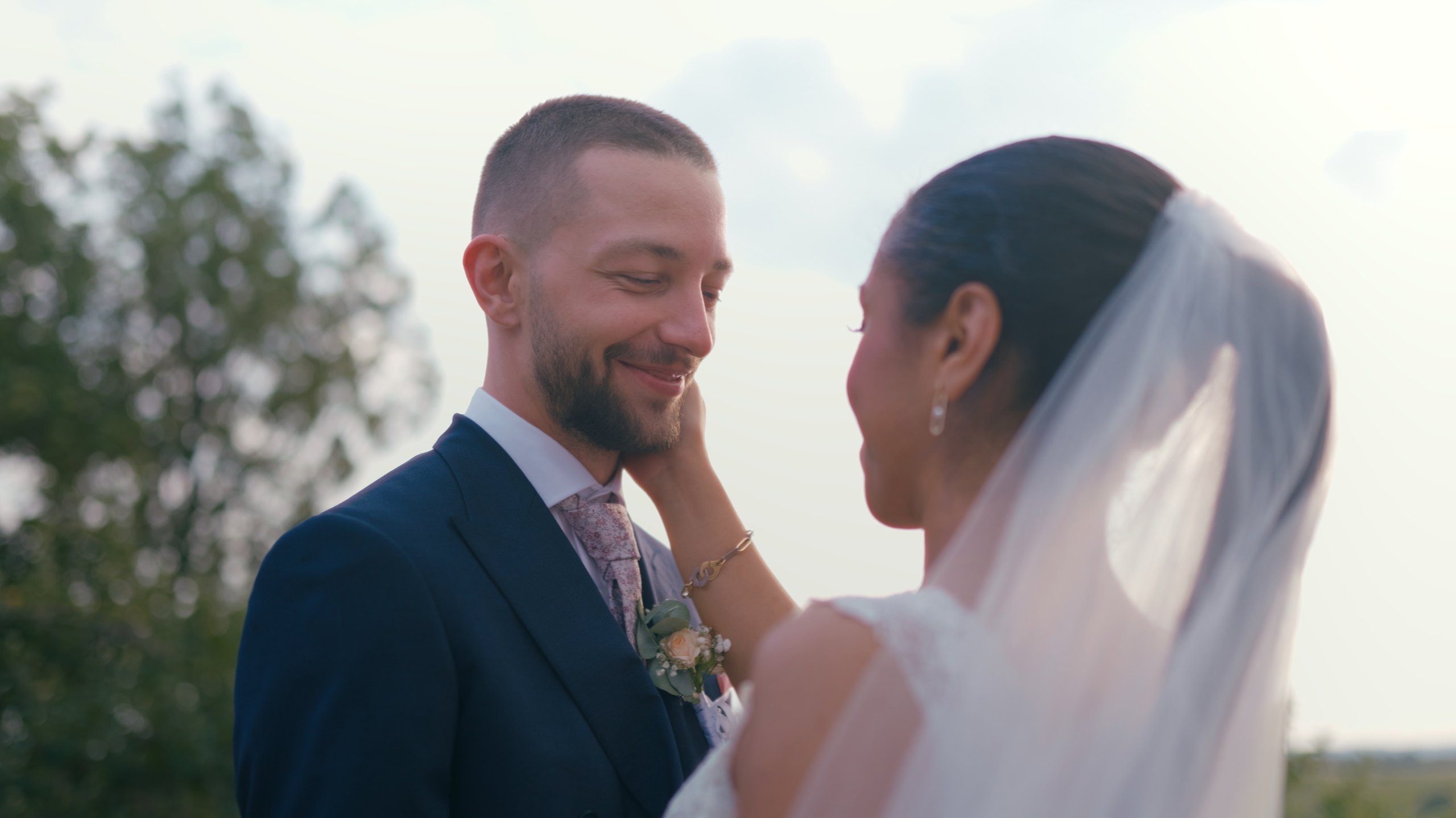Angélique resting her hand on Dorian’s cheek during the couple portraits